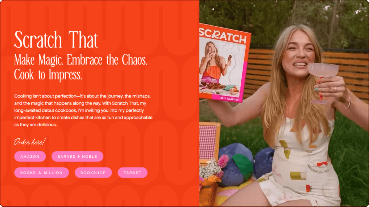 A woman sitting on a picnic blanket outdoors holds up a cookbook titled "Scratch" and a cocktail, smiling at the camera. A red sidebar displays the book title, description, and purchase options. | Wonderly